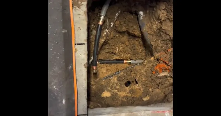 Excavated sewer pipe and repair trench outside a property for Cold Storage Plumbing Services in Tolleson, AZ