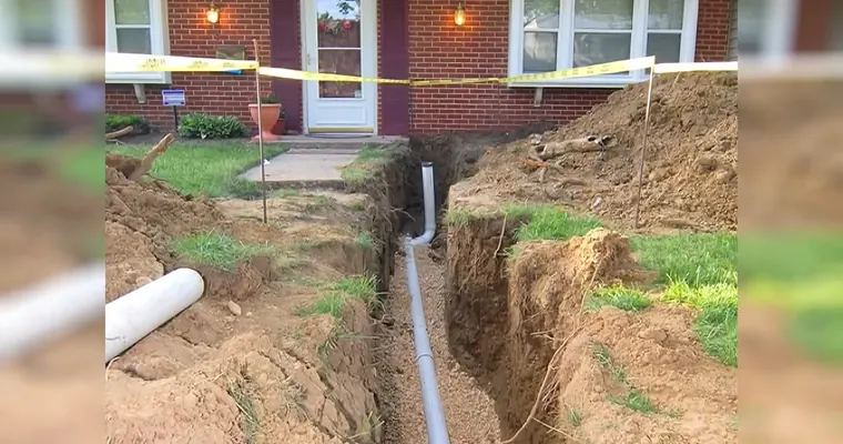 Plumbing technician working on visible pipe connections for Trenchless Sewer Repair in Tolleson, AZ
