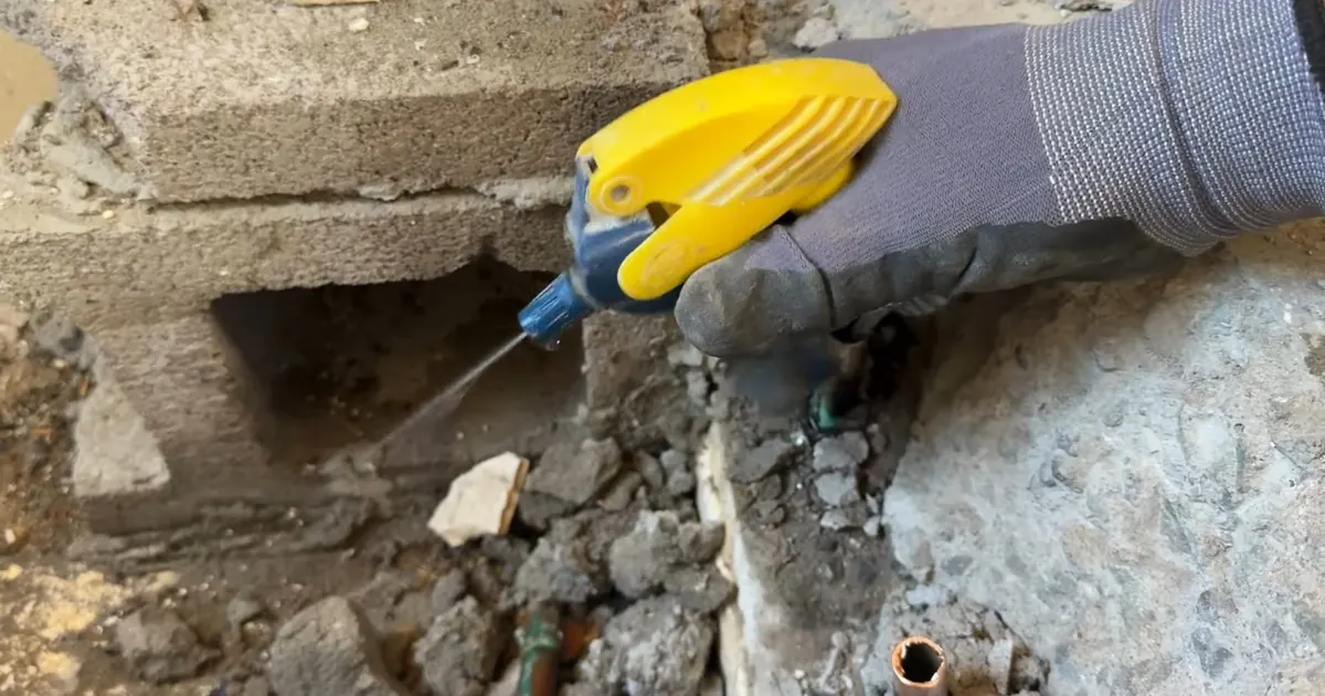Plumbing technician working on visible pipe connections for Why Tolleson Water Runs 16 to 19 Grains Per Gallon