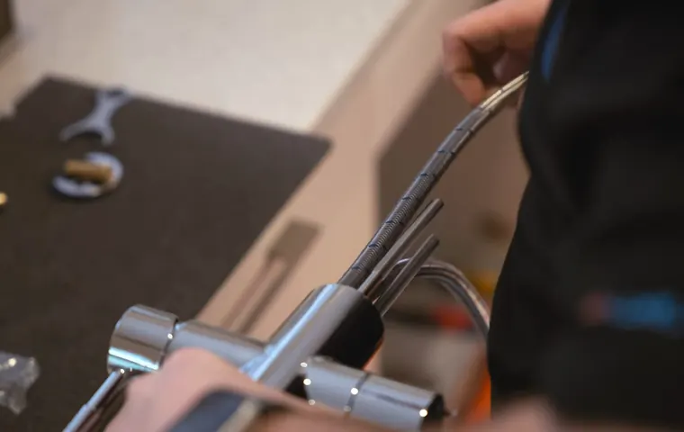 Sink faucet and drain connection being adjusted under a cabinet for Faucet and Fixture Repair in Tolleson, AZ