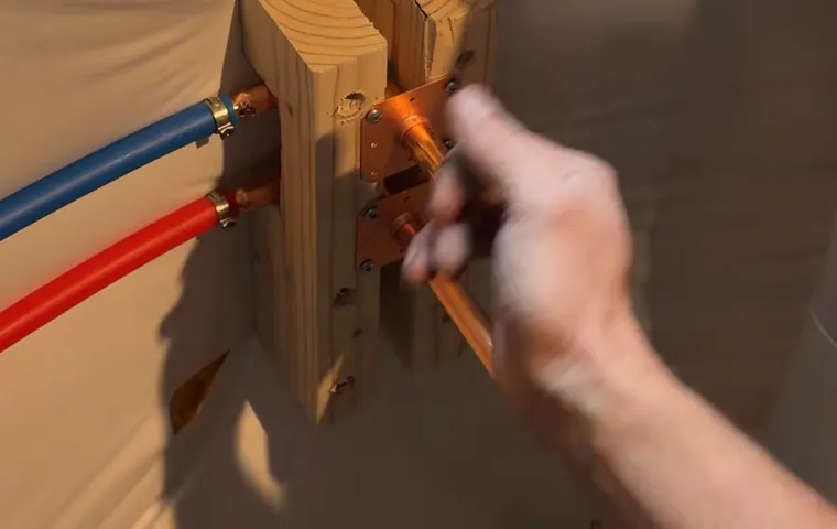 Sink faucet and drain connection being adjusted under a cabinet for Plumber Serving West Phoenix, AZ in Tolleson